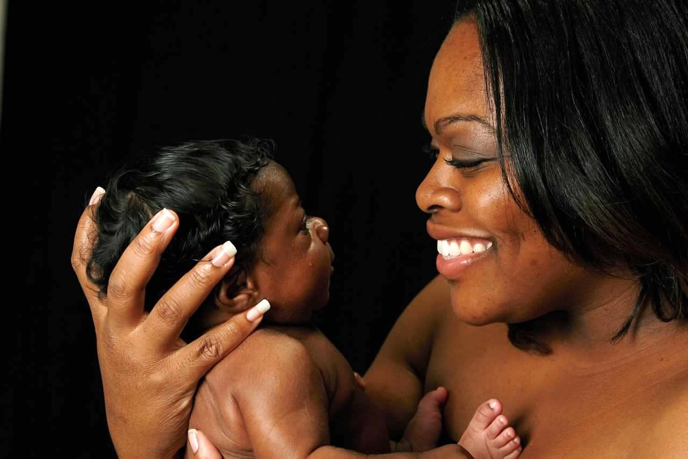 Mother holding her child closely in a quiet, intimate moment
